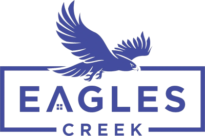 A blue eagle is flying over the words eagles creek.